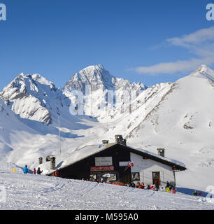 La Thuile, Italie - Février 18, 2018 : skieurs et planchistes à côté d'une cabane en bois dans les Alpes italiennes au cours de l'hiver, avec copie espace Banque D'Images