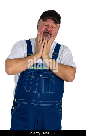 Impuissance homme portant salopette avec cap standing against white background Banque D'Images