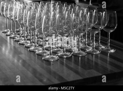 Photo en noir et blanc de verres de vin sur une table Banque D'Images