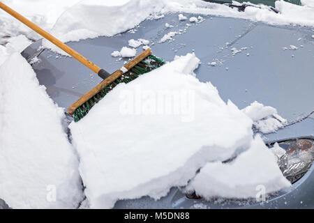 Balayer avec un balai voiture neige Banque D'Images