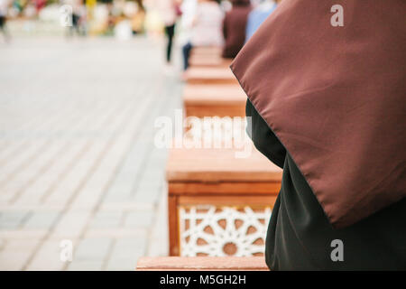 Photo conceptuelle d'une femme portant un hijab assis dans la place Sultanahmet à Istanbul, Turquie. Banque D'Images