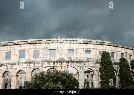 L'antique Colisée romain de Pula, Croatie contre un ciel d'orage. Banque D'Images