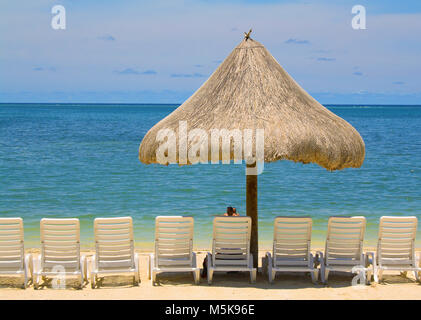 Chaises longues et parasol à la plage de Turquoise Bay Resort, l'île de Roatan, Bay Islands, Honduras, Caraïbes Banque D'Images