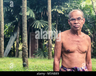 Ancien jardinier thai ,l'homme ne portait pas de chemise, dans le jardin en caoutchouc Banque D'Images