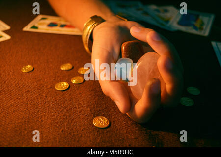 Les cristaux et d'or tenant la main sur la table de tarot Banque D'Images