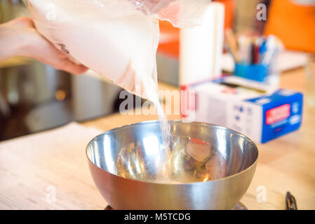 Verser de l'eau dans une casserole Banque D'Images