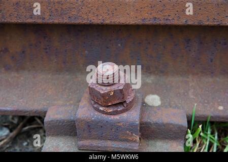 Old rusty rails dans gare approuvé pour la démolition. Détails de fer, rails joint avec gap, l'écrou et la vis. Photo Gros Plan avec selective focus Banque D'Images