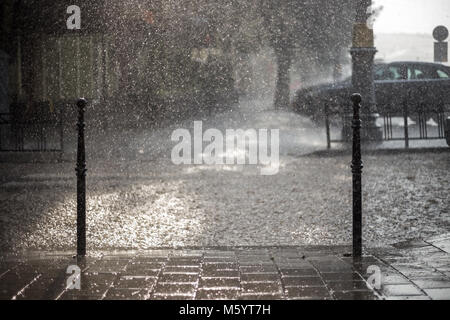 La pluie dans la ville. Road, chaussée, location dans la pluie, Close up. Les projections d'eau, les déversements sur route. Banque D'Images