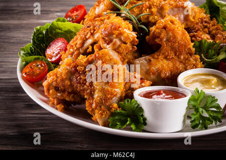 Nuggets de poulet frit et des légumes sur fond de bois Banque D'Images