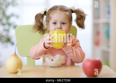 Tout-petit enfant mignon à la maison de l'eau potable Banque D'Images