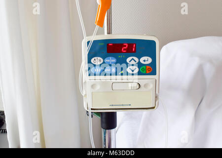 L'alimentation de la pompe à perfusion perfusion IV dans la chambre du patient à l'hôpital sur fond flou. Banque D'Images