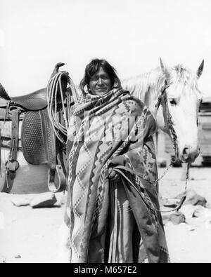 1930 Native American Indian MAN WEARING BLANKET STANDING BY HORSE LOOKING AT CAMERA COCHITI PUEBLO NOUVEAU MEXIQUE USA - i1279 HAR001 HARS 40-45 ANS UN ANIMAL D'AMÉRIQUE DU NORD RÉSERVATION FIERTÉ Mammifères Les mammifères mâles Cochiti Pueblo MID-ADULT MID-ADULT MAN AMÉRICAINS AUTOCHTONES NOUVEAU MEXIQUE B&W NOIR ET BLANC PHOTO AUTOCHTONES PERSONNES ANCIENNE Banque D'Images