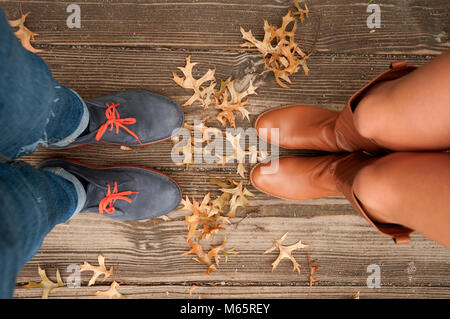 Couple Homme et Femme pieds dans l'amour en plein air romantique avec les feuilles d'automne Banque D'Images