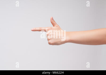 La main de femme à un doigt points quelque chose sur fond blanc. Banque D'Images