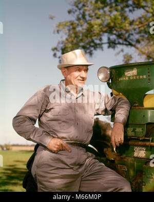 1970 PORTRAIT DE SÉRIEUSES HOMME MÛR FARMER LEANING ON TRACTEUR JOHN DEERE - kf4524 HAR001 HARS NOSTALGIE TRANSPORT AGRICULTURE D'ÂGE MOYEN HOMME D'ÂGE MOYEN 55 à 60 ans 60 à 65 ans OBJET UNIQUE OCCUPATION COMPÉTENCES MACHINES COMPÉTENCES CARRIÈRES CROISSANCE DU TRAVAIL AGRICULTEURS JOHN DEERE GRIS HOMMES BEAUTÉ CAUCASIEN ETHNICITÉ AGRONOMIE DEERE PROFESSIONS LABORIEUSES PERSONNES ANCIENNE UNSMILING VÊTEMENTS DE TRAVAIL Banque D'Images