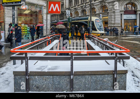 Milan, Italie - Mar 1st, 2018 : Particulièrement Froid et neige en raison d'un phénomène appelé 'bête de l'Est' frappe Milan, Lombardie, Italie. Metropolian entrée de la station Duomo sur la ligne de tramway M1 avec passage sur Crédit : Alexandre Rotenberg/Alamy Live News Banque D'Images