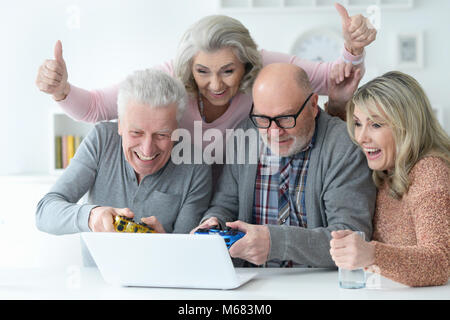 Senior couples playing computer game Banque D'Images
