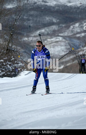Le capitaine de l'Armée de Ryan Batt, membre de l'équipe de biathlon de la Garde nationale de l'Idaho, participe à l'ouverture à l'événement sprint Chef du Bureau de la Garde nationale de Biathlon Championships, Soldier Hollow, Utah, le 25 février 2018. Au cours de l'épreuve de ski les biathlètes trois tours pour un total de 10 kilomètres (6,2 mi) pour les hommes et de 7,5 kilomètres (4,7 mi) pour les femmes. Ils piquent aussi deux fois à n'importe quel tournage lane, une fois exposées et une fois debout, pour un total de 10 coups. Pour chaque tir manqué, une boucle de pénalité de 150 mètres (490 ft) doit être skié la course peut être poursuivi. (U.S. Air National Guard Banque D'Images