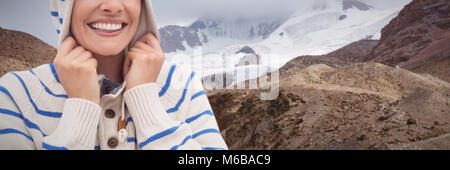 Composite image of cheerful woman wearing hooded sweater Banque D'Images