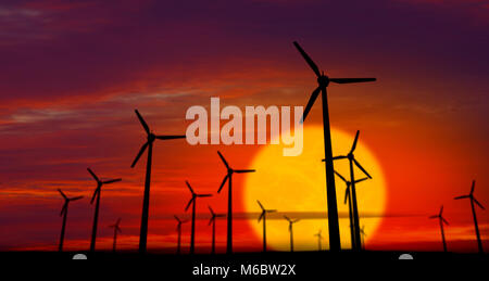 Moulins à vent énergie d'ossature sur fond coucher de soleil. Notion de puissance écologique. Banque D'Images