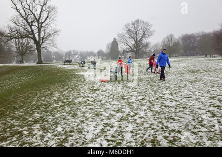 Carshalton Park, Londres. Le 3 mars 2018. Une famille donne jusqu'à la luge comme la neige commence à fondre, après le big freeze, le samedi 3 mars à Carshalton Park, Londres. Crédit : Darren Lehane/Alamy Live News Banque D'Images