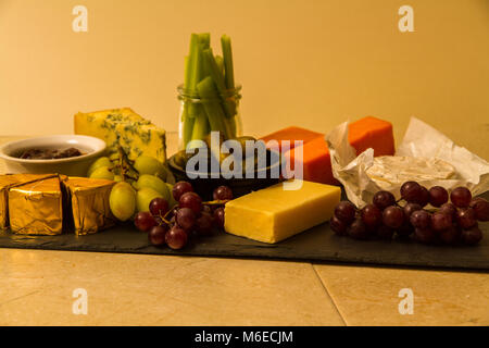 Plateau de fromages, de partage, de fromage, red leicester, stilton, cheddar, brie, camembert, raisins, cornichons au vinaigre, le céleri, le cornichon ou sla sur chutney Banque D'Images