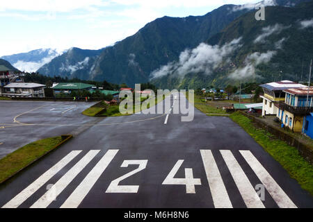 Petit avion à l'atterrissage à l'aéroport Tenzing-Hillary" 'à Lukla sur un jour nuageux, Camp de base de l'Everest trek, au Népal Banque D'Images