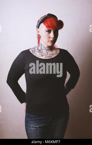 Edgy portrait d'une jeune femme avec de nombreux Tatouages et piercings faciaux Banque D'Images