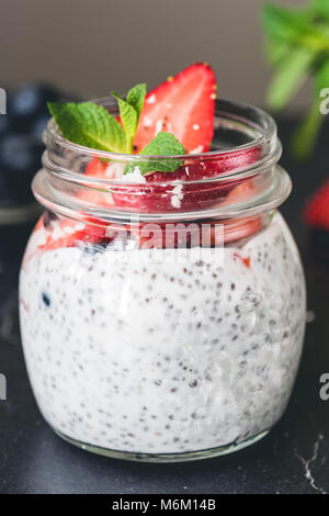 Chia pudding avec fraises et bleuets en pot. Vue rapprochée Banque D'Images