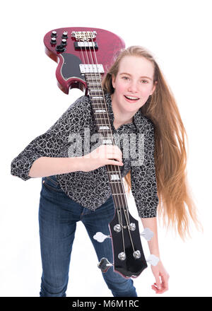 Teen blonde girl et guitare basse contre fond blanc en studio Banque D'Images