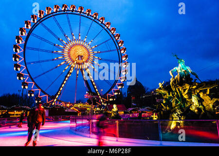 Neptunbrunnen, grande roue et de patinage sur glace à un marché d'hiver à Berlin, Allemagne Banque D'Images