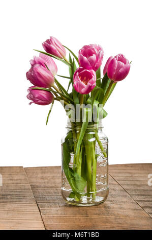 Tulipe rose dans un vase clair pot Mason Banque D'Images