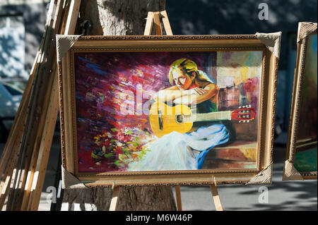 Peinture d'un joueur de guitare à vendre au marché en plein air d'Erevan, Arménie. Banque D'Images