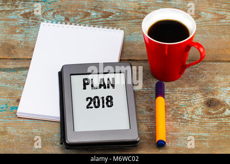 2018 Plan d'inscription sur e-book écran ou tablette. Tablet pc avec l'ordinateur portable ouvert et tasse de café sur le fond en bois. Banque D'Images