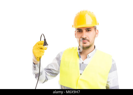 Young handsome electrician holding débranché un câble électrique isolé sur fond blanc Banque D'Images