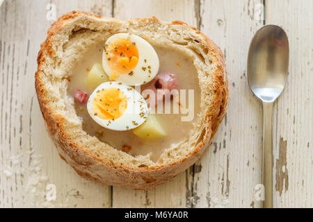 Soupe Zurek polonais traditionnel appelé avec des œufs et des saucisses sur fond de bois Banque D'Images