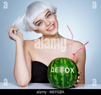 Funny smiling girl with watermelon cocktail sur fond bleu. Concept Detox Banque D'Images
