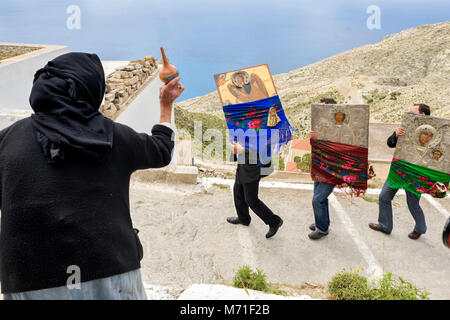 La Grèce, Îles de la mer Égée, l'île de Karpathos, procession du mardi de Pâques, un ancien du village se jette l'eau bénite sur les icônes Banque D'Images