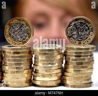 L'une des piles de pièces livre close up avec visage de femme en arrière-plan l'argent épargne concept isa Banque D'Images