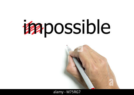 Main isolé et stylo rouge rend tout impossible d'être possible Banque D'Images