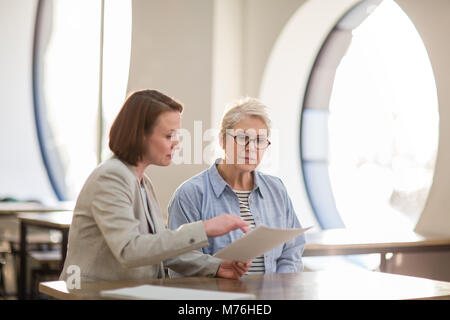 Senior woman with personal finance advisor Banque D'Images