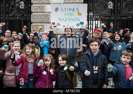 Londres, Royaume-Uni. 10 mars, 2018. Richard Radcliffe, mari de Nazanin Zaghari-Ratcliffe, se trouve à l'extérieur du ministère des Affaires étrangères et du Commonwealth avec les enfants et les amis et de la famille des pierres sur une holding peint peinture pierre événement pour marquer la Fête des mères et trois mois depuis Secrétaire aux affaires étrangères, Boris Johnson, en visite en Iran et promesse de ne laisser aucune pierre unturned". La peinture est entre la fille Gabriella Nazanin et passe-temps les plus chers à la prison d'Evin en Iran. Nazanin Zaghari-Ratcliffe a été emprisonné pendant 707 jours. Credit : Mark Kerrison/Alamy Live News Banque D'Images