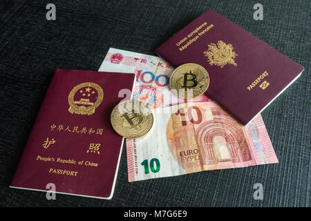 Les passeports chinois et français avec des euros et billets Yuan et des bitcoins Banque D'Images