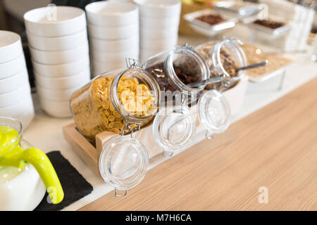 Hôtel buffet avec museli dans un bocal en verre, les raisins secs et les flocons de maïs Banque D'Images