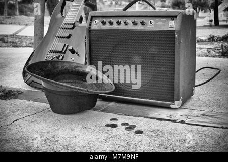 Vieille guitare et l'amplificateur à côté d'un banc de parc, un concept de la musique de rue Banque D'Images