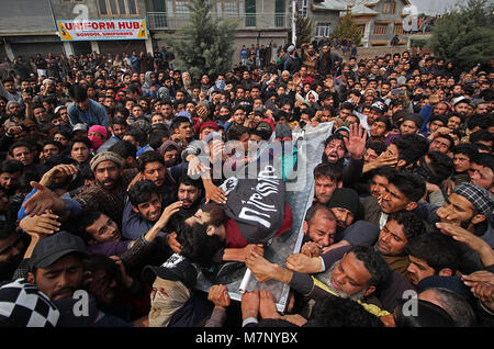 Le cachemire. 12 mars, 2018. Les gens portent le corps d'un militant local Eesa Fazili Soura en matière de Srinagar, la capitale d'été du Cachemire sous contrôle indien le 12 mars 2018.Des milliers de personnes ont participé à la prière funéraire de militant tué Fazili à Ahmadnagar, dans la banlieue de Srinagar. Fazili un étudiant en ingénierie a été tué dans une fusillade avec ses deux associés dans Hakura village de South d'Anantnag du Cachemire. La police a déclaré . Banque D'Images