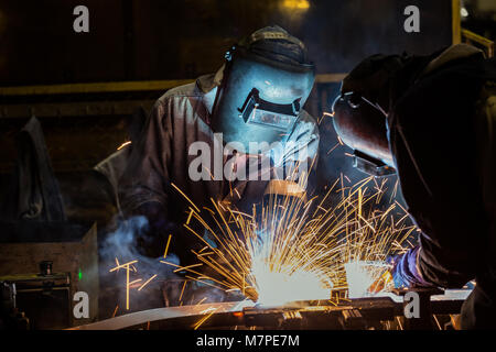 Les travailleurs industriels avec masque de protection sont en métal de soudure Banque D'Images