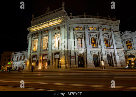 Low angle statique photo de nuit de tram arrivant à l'arrêt en face de Burgtheater de Vienne Banque D'Images