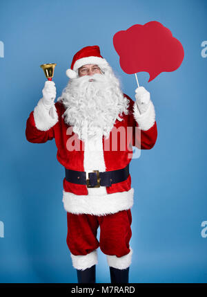 Santa Claus holding speech bubble et Bell Banque D'Images