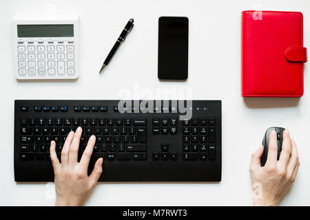 Vue de dessus, woman sitting at desk et travaillant sur son pc, sa table est parfaitement bien rangé et organisé Banque D'Images